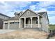 Charming home featuring a welcoming front porch, complemented by a two-car garage and stone accents at 3895 Buttongrass Trl, Castle Rock, CO 80108