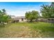 Large backyard featuring a sprawling lawn, mature trees, garden area and patio area for enjoying the outdoors at 10007 Bryant St, Denver, CO 80260