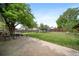 Large backyard featuring a grassy lawn, mature trees, and a concrete patio area ideal for relaxation and entertainment at 10007 Bryant St, Denver, CO 80260