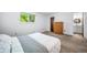 Bedroom with carpet flooring, window with a view, a dresser, and en suite bathroom at 10007 Bryant St, Denver, CO 80260
