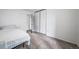 Bright bedroom with a large closet with slider doors and a bed with neutral carpet at 10007 Bryant St, Denver, CO 80260