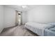 Bright bedroom with a large window, neutral carpet and a twin bed with gray and white bedding at 10007 Bryant St, Denver, CO 80260