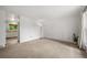 Bright living room featuring neutral carpet, fresh white walls, and a large window allowing ample natural light at 10007 Bryant St, Denver, CO 80260