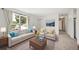 Staged living room enhanced with a plush sofa, accent chairs, and stylish decor creating a cozy and inviting atmosphere at 10007 Bryant St, Denver, CO 80260
