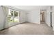Bright living room featuring neutral carpet, fresh white walls, and a large window allowing ample natural light at 10007 Bryant St, Denver, CO 80260