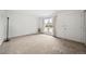 Bright living room with large window, neutral carpet, and freshly painted white walls for modern elegance at 10007 Bryant St, Denver, CO 80260
