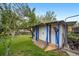 Backyard shed for storage with work area and a tidy green lawn, plus trees for privacy and shade at 10007 Bryant St, Denver, CO 80260
