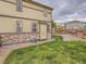 Landscaped backyard featuring a grassy lawn, gravel, and a wooden fence at 4862 S Piccadilly Ct, Aurora, CO 80015