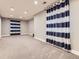 Spacious carpeted basement featuring modern lighting fixtures and neutral paint at 4862 S Piccadilly Ct, Aurora, CO 80015