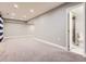 Finished basement area leading to a bathroom with neutral walls and carpeted floors at 4862 S Piccadilly Ct, Aurora, CO 80015