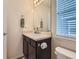 Cozy bathroom featuring a single vanity and natural light from the window at 4862 S Piccadilly Ct, Aurora, CO 80015