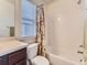 Bright bathroom featuring a shower-tub combination with a floral curtain at 4862 S Piccadilly Ct, Aurora, CO 80015