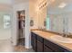 Bright bathroom featuring a double vanity, large mirror, walk-in closet, and a separate shower at 4862 S Piccadilly Ct, Aurora, CO 80015