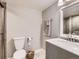 Updated bathroom featuring a gray vanity with marble countertop and modern fixtures at 4862 S Piccadilly Ct, Aurora, CO 80015
