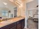 Well-lit bathroom featuring a double vanity and a glimpse into the bedroom at 4862 S Piccadilly Ct, Aurora, CO 80015