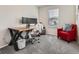 Bedroom featuring a modern desk setup, chair, and a comfortable armchair by the window at 4862 S Piccadilly Ct, Aurora, CO 80015