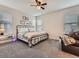 Neutral bedroom with comfortable bedding, ceiling fan, and natural lighting from the windows at 4862 S Piccadilly Ct, Aurora, CO 80015