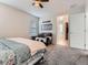 Spacious bedroom featuring a bed, comfortable seating, and a view into the closet at 4862 S Piccadilly Ct, Aurora, CO 80015