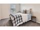 A nicely decorated bedroom features soft carpet and natural lighting from the window at 4862 S Piccadilly Ct, Aurora, CO 80015