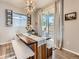 Charming dining area featuring a rustic wood table with bench seating and sliding glass doors at 4862 S Piccadilly Ct, Aurora, CO 80015
