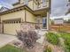 Inviting home exterior with stone accents, a cozy porch, and meticulous landscaping at 4862 S Piccadilly Ct, Aurora, CO 80015