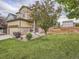 Charming two-story home with a well-maintained lawn and mature landscaping creates great curb appeal at 4862 S Piccadilly Ct, Aurora, CO 80015