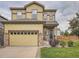 Beautiful home exterior featuring a two-car garage, stone accents, and well-kept lawn at 4862 S Piccadilly Ct, Aurora, CO 80015