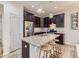 Kitchen with a granite island offering bar seating and stainless steel appliances at 4862 S Piccadilly Ct, Aurora, CO 80015