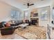 Comfortable living room featuring a stone fireplace, plush seating, and an inviting atmosphere at 4862 S Piccadilly Ct, Aurora, CO 80015
