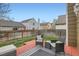 Backyard boasts a red deck with seating, a manicured lawn, and privacy fencing at 5648 S Youngfield Way, Littleton, CO 80127