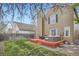 Red deck and lush backyard offer an inviting outdoor living and entertainment space at 5648 S Youngfield Way, Littleton, CO 80127