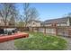 Large, grassy backyard includes a red deck and privacy fence for relaxation and entertaining at 5648 S Youngfield Way, Littleton, CO 80127