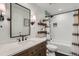 Bathroom with a shower/tub, vanity, large mirror, and black and white decor at 5648 S Youngfield Way, Littleton, CO 80127