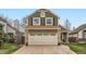 Charming two-story home featuring a brick facade, two-car garage and low-maintenance landscaping at 5648 S Youngfield Way, Littleton, CO 80127