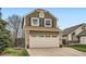 Charming two-story home featuring a brick facade, two-car garage and low-maintenance landscaping at 5648 S Youngfield Way, Littleton, CO 80127
