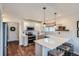 Well-lit kitchen with white cabinetry, stainless steel appliances, and cozy breakfast bar seating at 5648 S Youngfield Way, Littleton, CO 80127