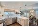 Bright kitchen with white cabinetry, stainless steel appliances, and an island with seating at 5648 S Youngfield Way, Littleton, CO 80127