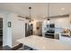 Updated kitchen with stainless steel appliances, white cabinetry and view of kitchen to laundry at 5648 S Youngfield Way, Littleton, CO 80127