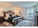 Bedroom features a large bed, plush rug, and bright window at 5648 S Youngfield Way, Littleton, CO 80127