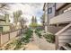 Backyard featuring a multi-tiered yard, fencing, partial deck views, and mature trees at 187 W Prestwick Ct, Castle Rock, CO 80104