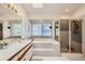 Well-lit bathroom with a shower, tub, and large windows offering pleasant views at 187 W Prestwick Ct, Castle Rock, CO 80104