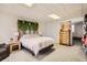 Bedroom featuring a barnwood headboard decorated with greenery, neutral walls, and gray carpet at 187 W Prestwick Ct, Castle Rock, CO 80104