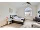 Bright bedroom featuring a ceiling fan, and a large window providing natural light at 187 W Prestwick Ct, Castle Rock, CO 80104