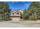 Charming two-story home with attached garage, mature trees, and landscaped front yard at 187 W Prestwick Ct, Castle Rock, CO 80104