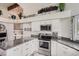 Bright kitchen boasts granite countertops, stainless steel appliances, and vaulted ceilings at 187 W Prestwick Ct, Castle Rock, CO 80104