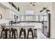 Updated kitchen with white cabinets, stainless steel appliances, and bar stool seating at 187 W Prestwick Ct, Castle Rock, CO 80104