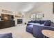 Bright living room features a cozy fireplace and vaulted ceilings at 187 W Prestwick Ct, Castle Rock, CO 80104