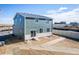Rear exterior of home with green siding, white trim, sliding glass door and yard at 3889 N Shawee St, Aurora, CO 80019