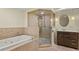 Bathroom features a glass-enclosed shower, soaking tub, and custom tiling at 2716 N Vine St, Denver, CO 80205