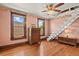Charming bedroom featuring hardwood floors, vintage furniture, and staircase to a loft area at 2716 N Vine St, Denver, CO 80205
